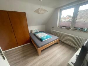 a small room with a bed and a window at Monteurzimmer Zimmer + WC in Willingen