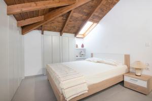a bedroom with a large bed and wooden ceilings at PanoramiKos in Asfendioú +14 photos