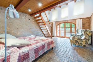 a bedroom with a bed and a chair at NEW! VILLA Can Rito PARA 16 PERSONAS, PISCINA, JARDINES y RELAX in Felanitx +48 photos