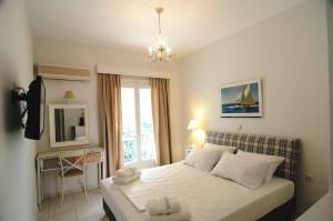 a small bedroom with a bed and a window at Arolithos in Spetses