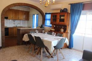 a kitchen with a table with chairs around it at River House, T2 Tavira – Santa Luzia in Tavira