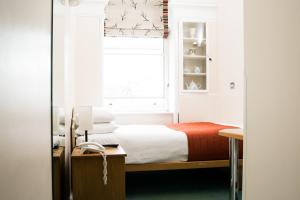 Säng eller sängar i ett rum på Hotel 63