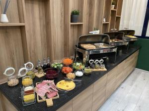 a buffet line with many different types of food at Volga Apart Hotel in Moscow