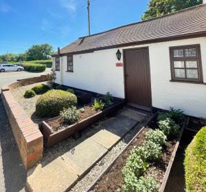 a house with a garden in front of it at Halfway House Inn & Cottages in Bridgnorth