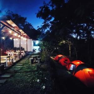 a group of tables and benches in a park at night at Bromo Tanjung in Tosari