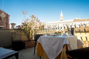 a table on a balcony with a view of a building at Hotel Antigo Trovatore in Venice