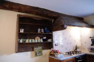 a kitchen with a sink and a shelf with cups at Erebia Appartamenti Vacanza in Villadossola