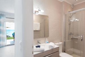 a bathroom with a sink and a shower and a toilet at Waves Apartments Melody Glyfada in Glyfada +69 photos