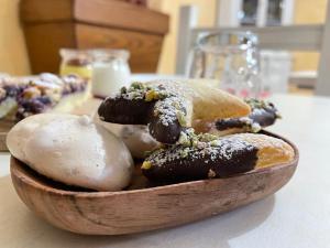 a wooden bowl filled with donuts and mushrooms on a table at B&B Fonte Vena in Norcia