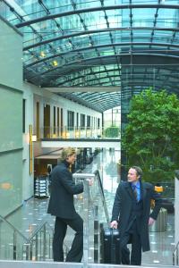 a man and a woman standing in front of a building at Maritim Hotel Düsseldorf in Düsseldorf