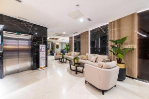 a lobby with couches and chairs in a building at Aprilis Deluxe Hotel in Istanbul