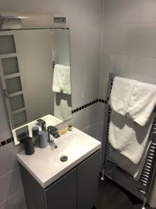 a bathroom with a sink and a mirror at The Dolphin Tavern in Penzance