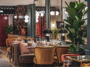 a restaurant with a long table and chairs at Dandy Hotel in Paris