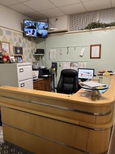 an office with a reception desk and a chair at California Guest House in Blackpool