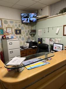 an office with a desk with a glass counter top at California Guest House in Blackpool