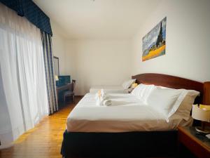 Postel nebo postele na pokoji v ubytování Hotel Hermitage
