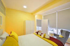 a bedroom with yellow walls and a bed with yellow pillows at RH Charming Apartment Liberdade II in Braga