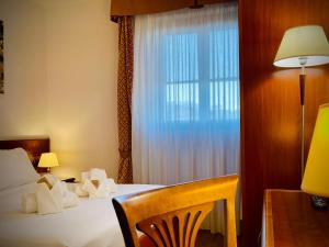 Postel nebo postele na pokoji v ubytování Hotel Hermitage