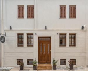 a building with a wooden door and windows at Hypnos Cozy Living in Ioannina