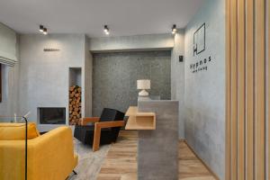 a living room with a yellow couch and a table at Hypnos Cozy Living in Ioannina