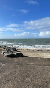 a rock formation on the beach near the ocean at appartement spacieux et lumineux proche de la plage in Quimiac