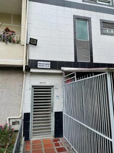 a building with a door and a fence in front of it at Apartamento Amoblado laureles estadio in Medellín