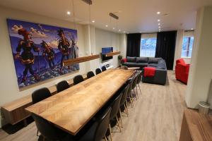 a conference room with a large wooden table and chairs at Hotel Hullu Poro in Levi