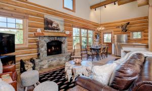 a living room with a couch and a fireplace at Powder Ridge Cabin - 9A Red Cloud in Big Sky