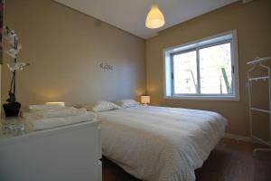 a bedroom with a large bed and a window at HEART OF THE CITY 7 ! in Vila Nova de Gaia