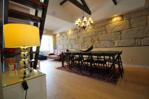 a dining room with a table and a stone wall at HEART OF THE CITY 7 ! in Vila Nova de Gaia