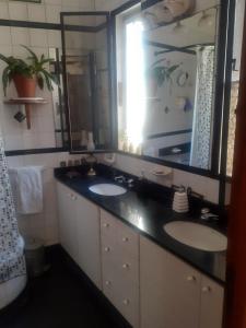 a bathroom with two sinks and a large mirror at Corazón de Palermo Soho in Buenos Aires +54 photos