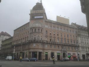 a large building with a clock tower on top of it at Centerpoint Panzio Digital Pansion Heritage Collection in Budapest