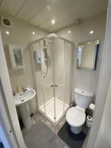 een badkamer met een douche, een toilet en een wastafel bij Blackpool Abode - 124 Elite Apartments in Blackpool