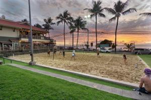 a group of people playing a game on a beach at Kahaluu Bay Village 201 by Casago Kona - Snorkeling, Surfing and Spaciousness in Kailua-Kona