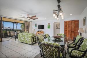 a living room with a table and chairs at Kahaluu Bay Village 201 by Casago Kona - Snorkeling, Surfing and Spaciousness in Kailua-Kona