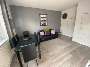 a living room with a table and a couch at Blackpool Abode - 124 Elite Apartments in Blackpool