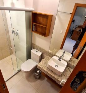 a bathroom with a toilet and a sink and a shower at Salinas Exclusive Resort in Salinópolis +9 photos