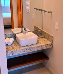 a bathroom counter with a sink and a mirror at Salinas Exclusive Resort in Salinópolis