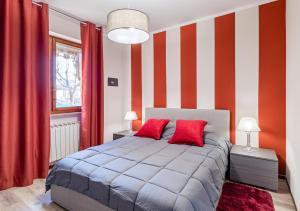 una camera con letto a righe rosse e bianche di Garden house - con Terrazzo a Grugliasco