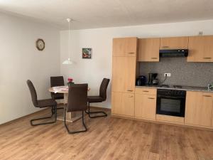 a kitchen with a table and chairs in a room at Ferienwohnung Engelhardt in Oberreute