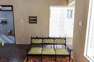 a bed sitting in a room with a window at Vila Barroca Estalagem in São Cristóvão