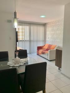 a living room with a dining table and a bed at Apartamento Manaíra pertinho do Mar in João Pessoa