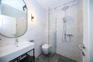 a white bathroom with a sink and a shower at Villa Sonja in Zadar +60 photos