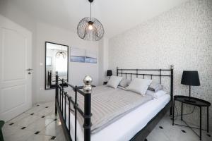 a bedroom with a bed and a chandelier at Villa Sonja in Zadar