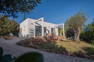 a house on a hill with a stone driveway at Gato Preto de Silves - Adults Only in Silves
