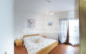 Postel nebo postele na pokoji v ubytování 15B - Grazioso appartamento riservato a Porto Mannu