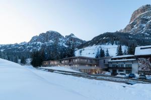 a resort in the mountains with snow on the ground at Movi Family Apart-Hotel ****s in Corvara in Badia