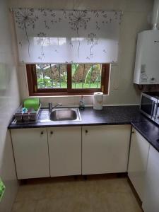 a kitchen counter with a sink and a window at Villa Jansson in Jávea