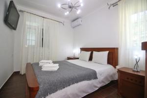 a bedroom with a bed with a television and a bed sidx sidx sidx at Eira Costa House by Gerês Casas in Geres +46 photos