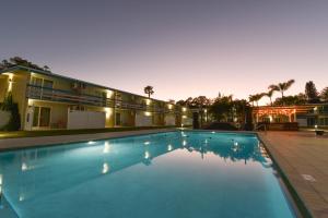 a large swimming pool in front of a building at Golden Host Resort Sarasota in Sarasota